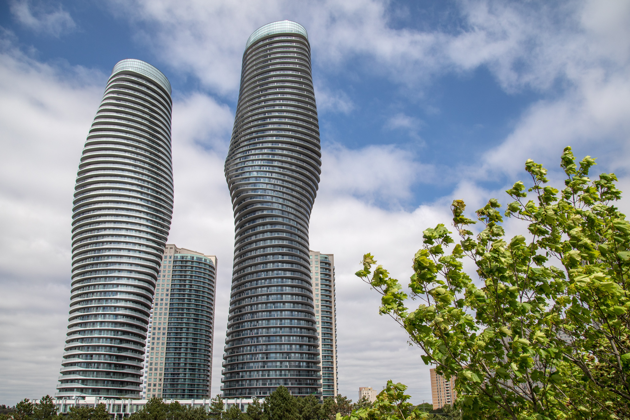 Twisting towers of Mississauga under a cloudy sky, showcasing CPM's robust moving services in urban landscapes.