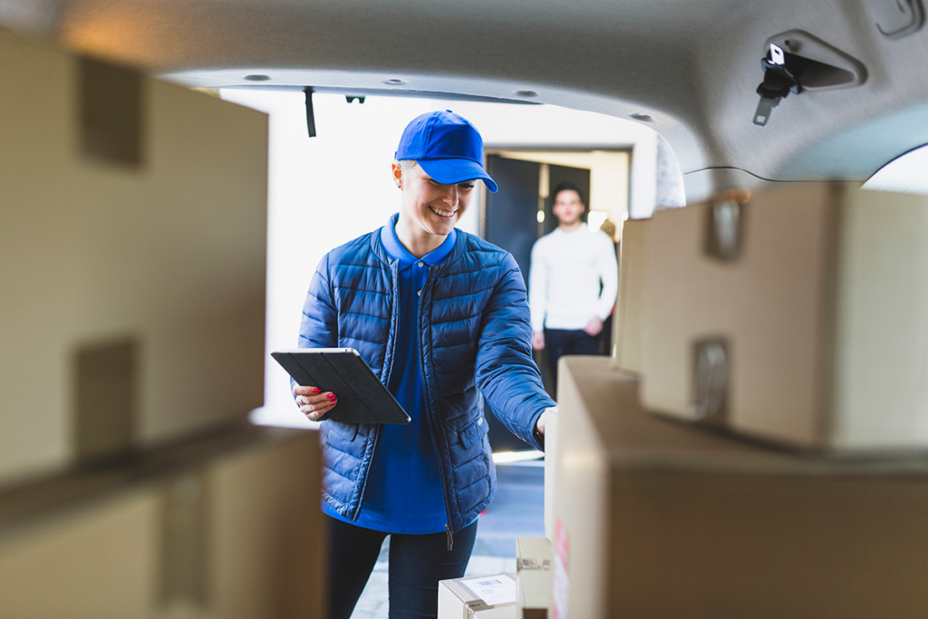 Movers carrying boxes into a new home