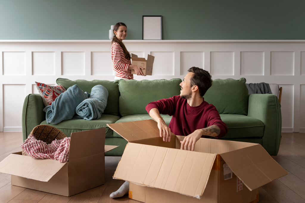 Team of movers packing household items into boxes