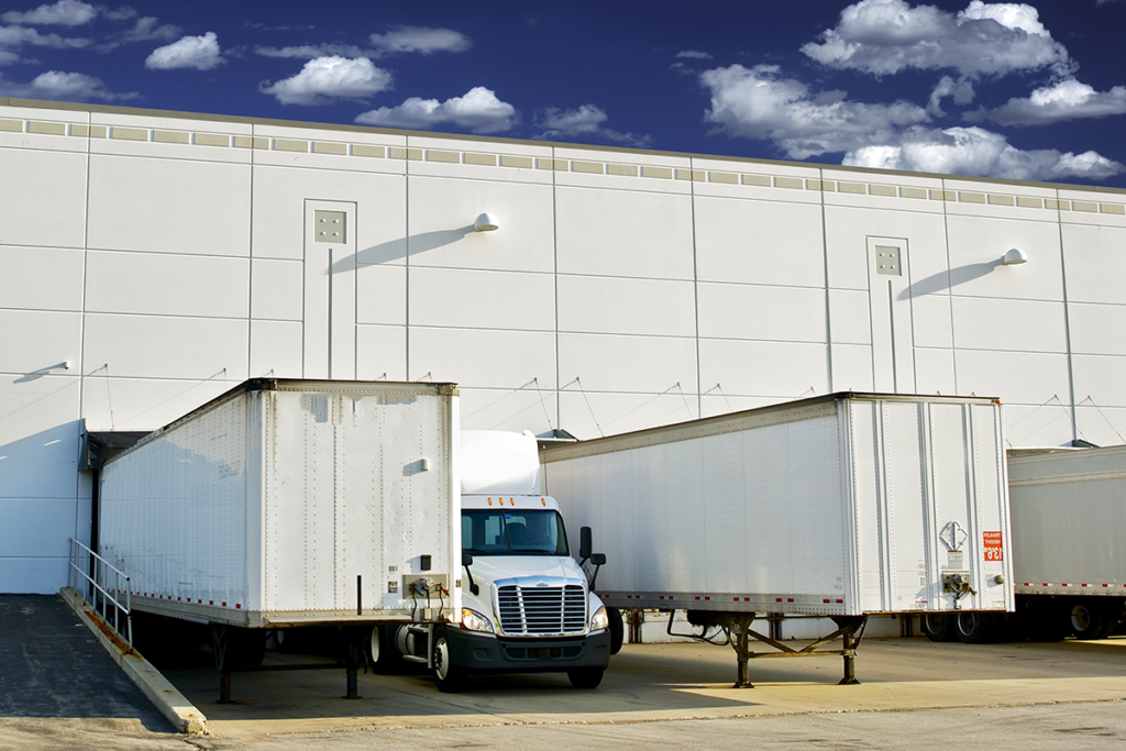 Moving and storage containers being loaded onto a truck