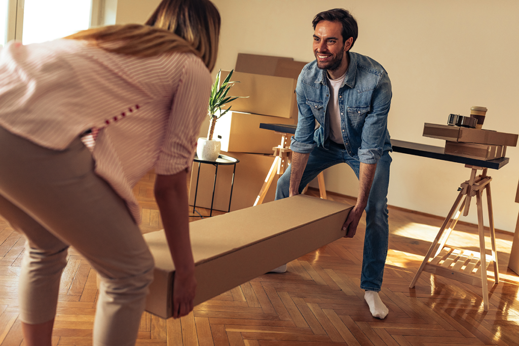 A happy family unpacking boxes in their new home, smiling and organizing their space.