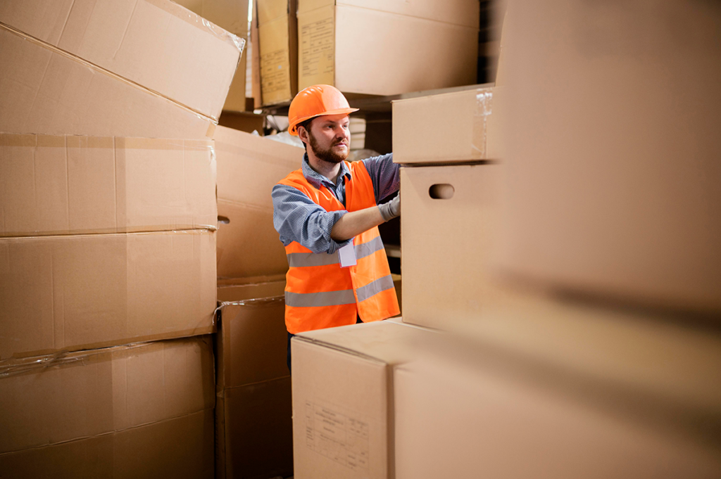 Specialist from a moving company organizing belongings in a storage unit