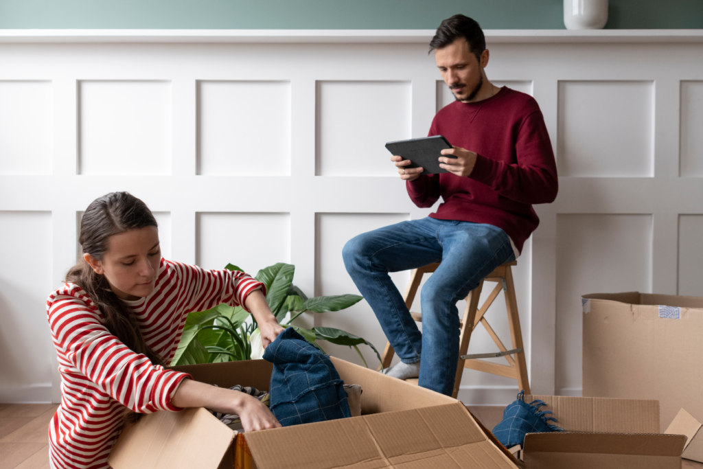 A family checking off items on a moving checklist while packing.