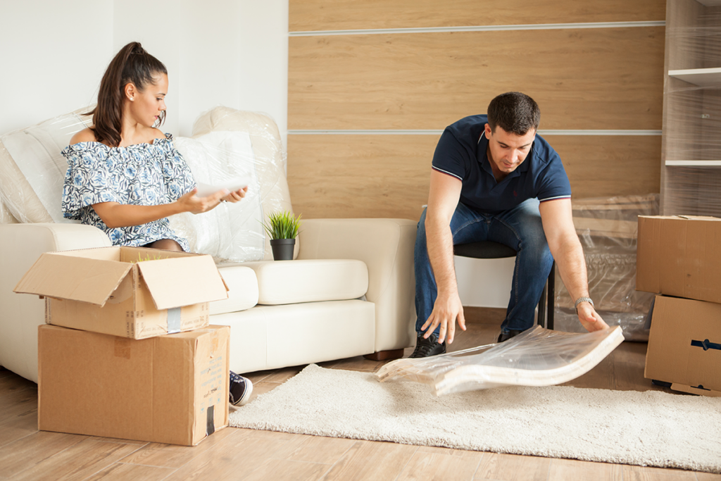 women hands wrapping a fragile item in bubble wrap