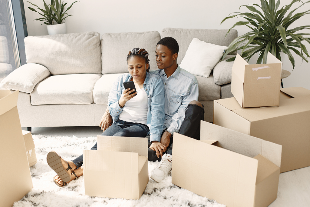 A couple reviewing their moving checklist on a phone