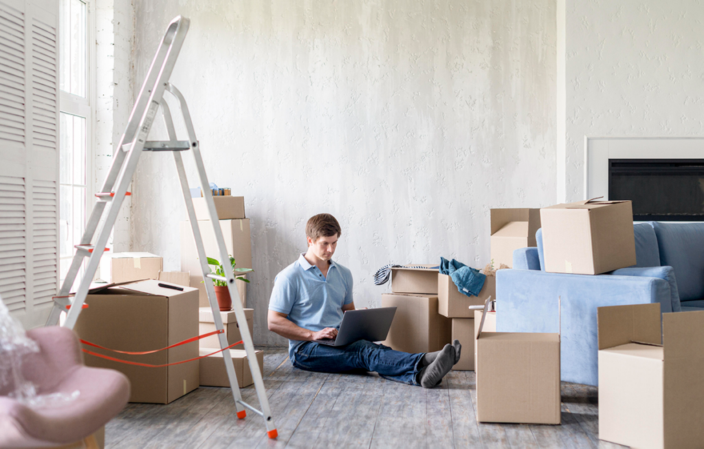 Person packing moving boxes in a living room