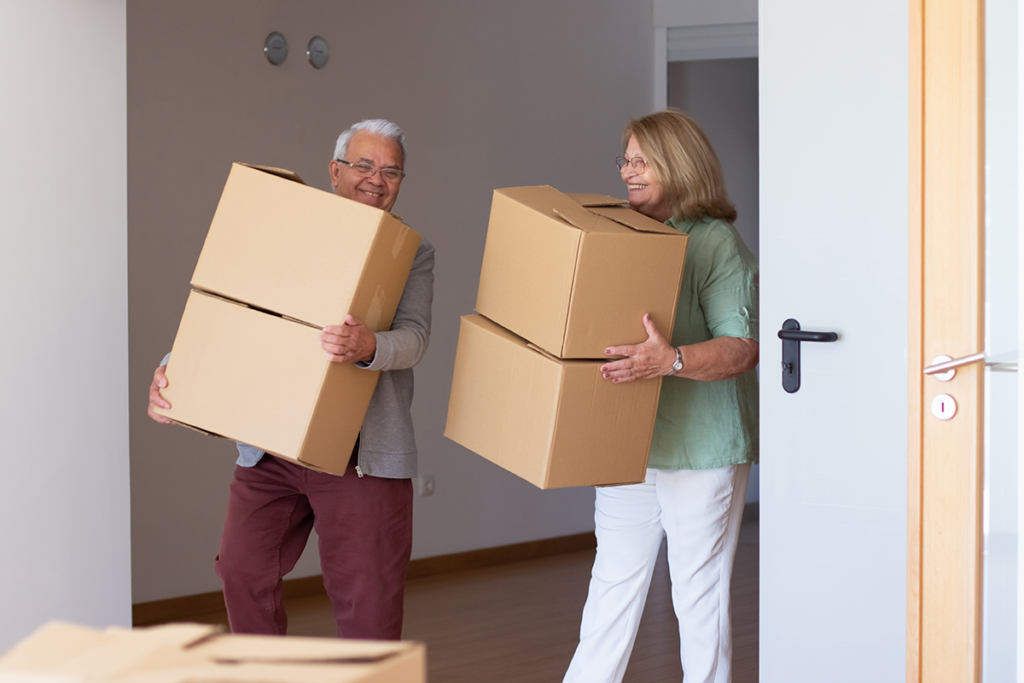 Family preparing for a long-distance move with boxes and packing materials