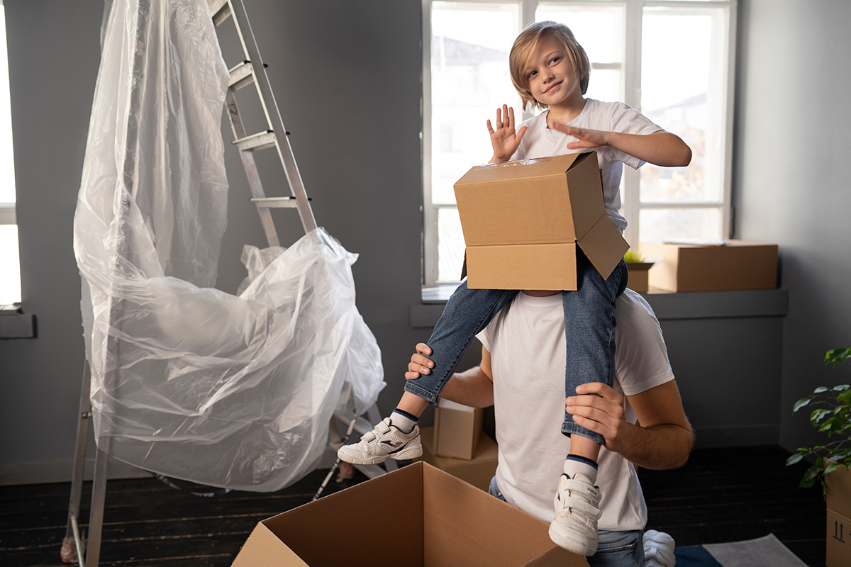 Joyful family unpacking boxes together, enjoying their new home and the moving process.