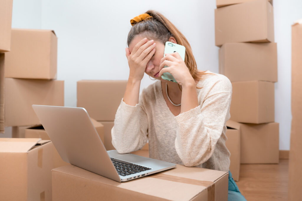 Caucasian woman with headache from moving to new home 