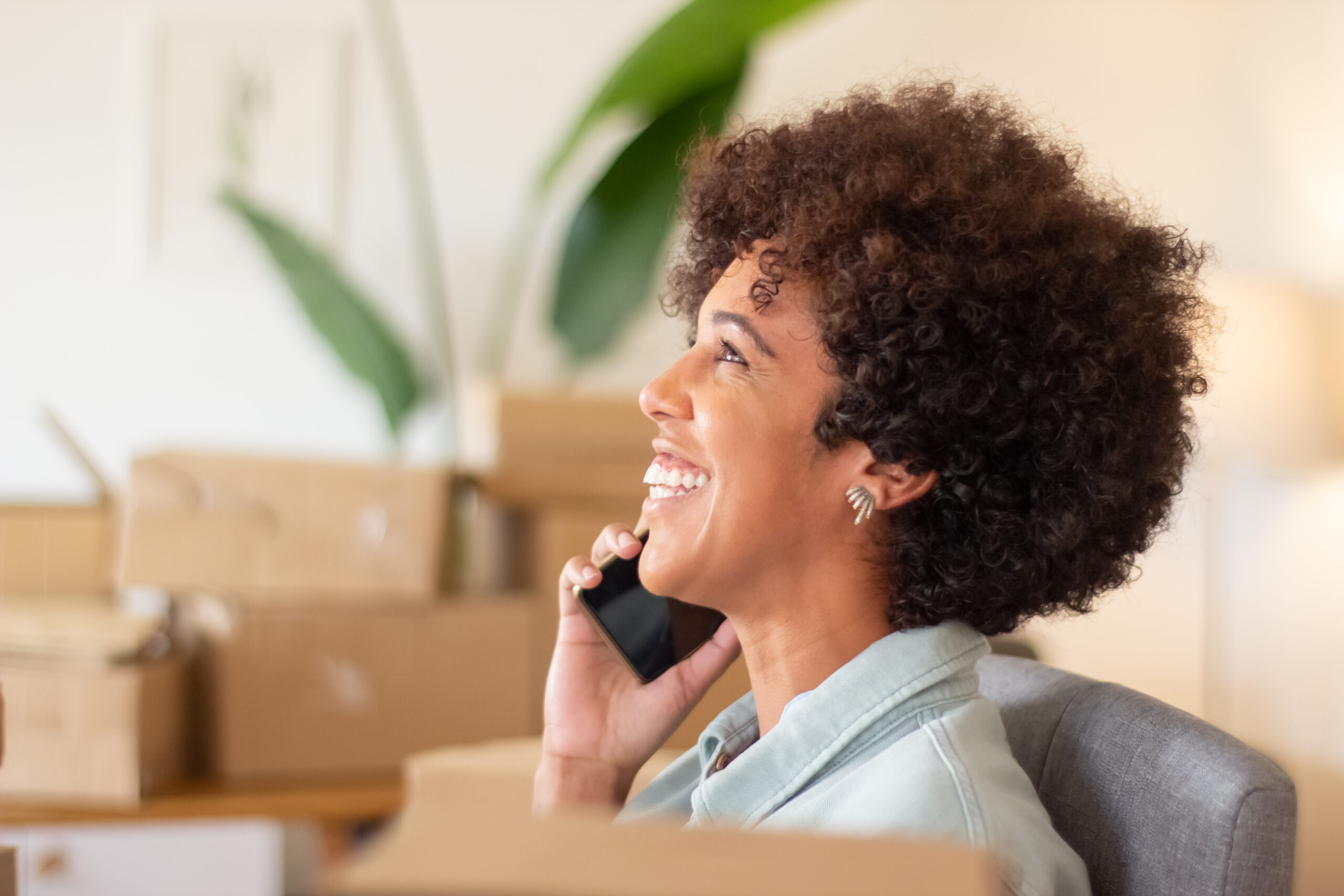 Moving services customer rep is calling client and smiling