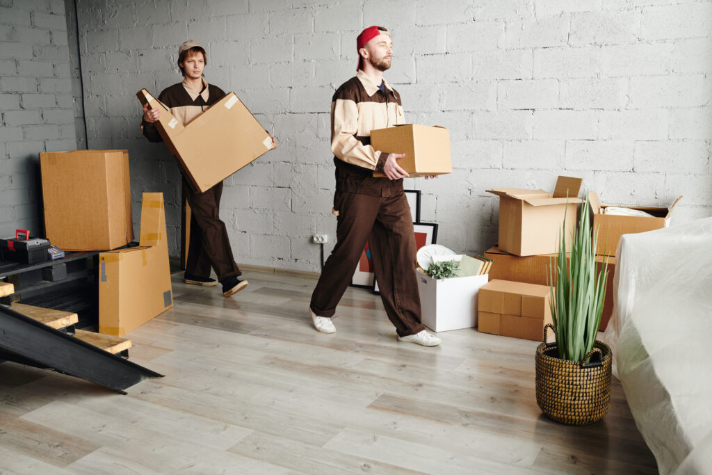 Professional movers carrying boxes, representing affordable moving services.