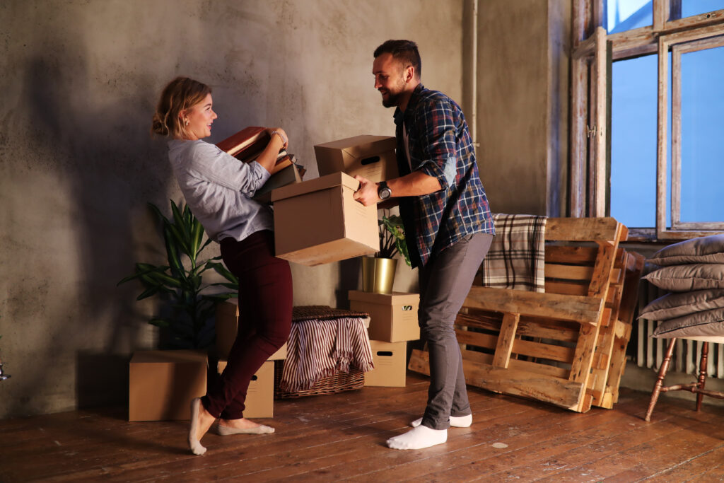 A family unpack belongings in their new living room.
