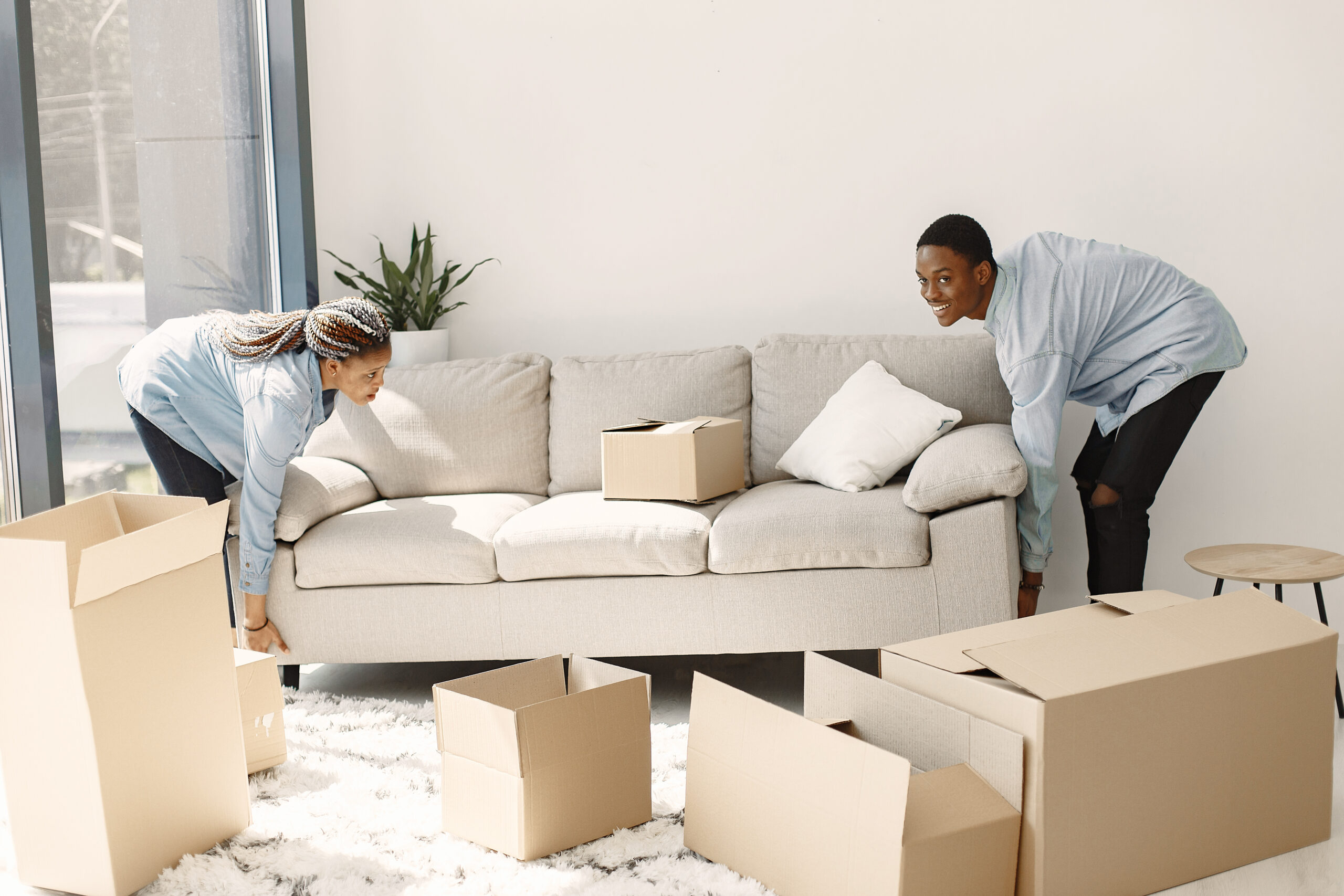 Young couple moving in to new home together. African american couple with cardboard boxes.